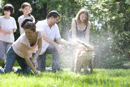 Dog washing: Keeping your furry pets healthy includes keeping them clean, as well.: Together, this family was in the process of washing their Labrador retriever outside in the fresh air. The mother, young daughter and son, were soaping down the dog’s coat, while the father was steadying the pet using a leash and his hand. By washing down his coat, chances for the animal to bring contaminants indoors, is highly reduced. After returning from the outdoors, pets can bring allergens, disease vectors such as ticks and fleas, and pathogens from other animals indoors, thereby exposing the entire family to these dangers. One should remember to wash his/her hands after finishing this activity. Caption and Image from Centers for Disease Control and Prevention Public Health Image Library, Atlanta, GA). Image by CDC/ Dawn Arlotta